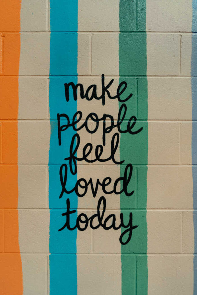 make people feel loved today - painted on school wall