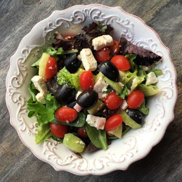 Hearty Greek Salad recipe in cream colored bowl