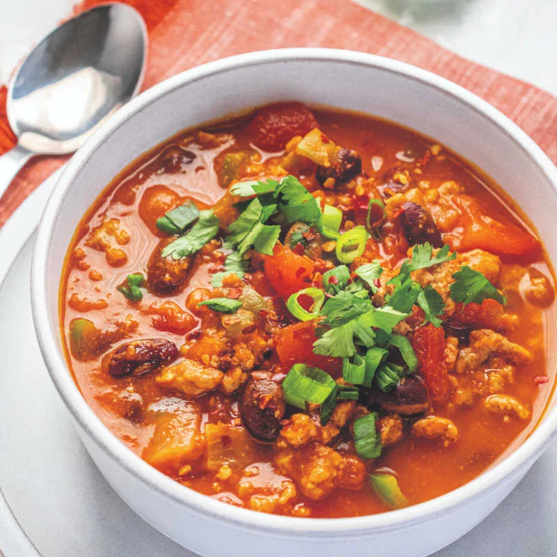 This Pumpkin Chili combines savory turkey, hearty beans and warm spices with creamy pumpkin for a comforting, flavorful twist on classic chili.