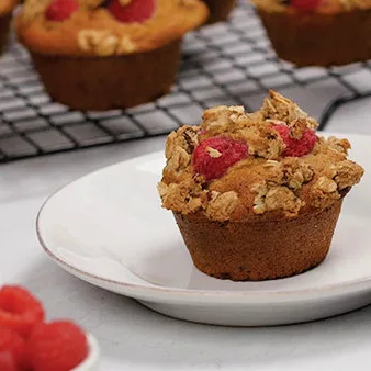 Raspberry Streusel Muffins feature a cinnamon-scented batter topped with juicy raspberries and finished with a crisp oat-pecan streusel that bakes into a golden, crumbly topping.