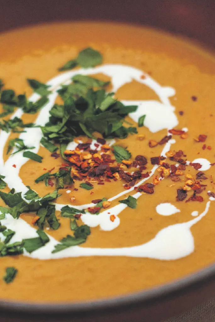 Creamy Pumpkin Soup starts with butter-sautéed vegetables, simmers with pumpkin and warm spices, then finishes with cream and honey for a smooth, comforting bowl of fall flavor.