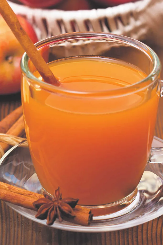 Pumpkin Spice Apple Bourbon Cocktail combines sautéed spiced apples with bourbon and pumpkin spice apple cider for a warm, aromatic drink finished with festive garnishes.