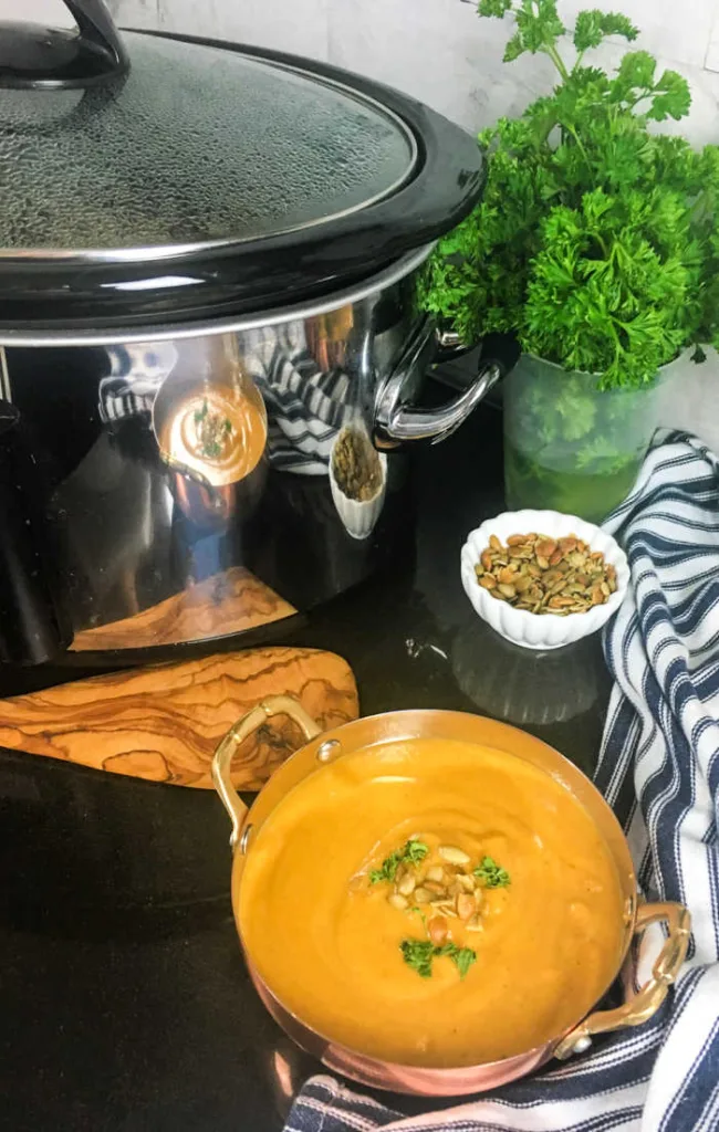 Crockpot Butternut Squash Soup slow-cooks squash, fruit, vegetables and warm spices, then blends into a creamy soup finished with toasted pumpkin seeds and fresh herbs.
