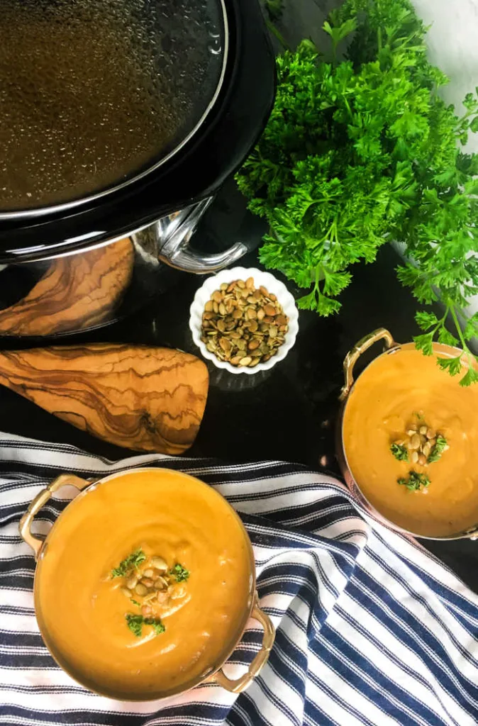 Crockpot Butternut Squash Soup slow-cooks squash, fruit, vegetables and warm spices, then blends into a creamy soup finished with toasted pumpkin seeds and fresh herbs.