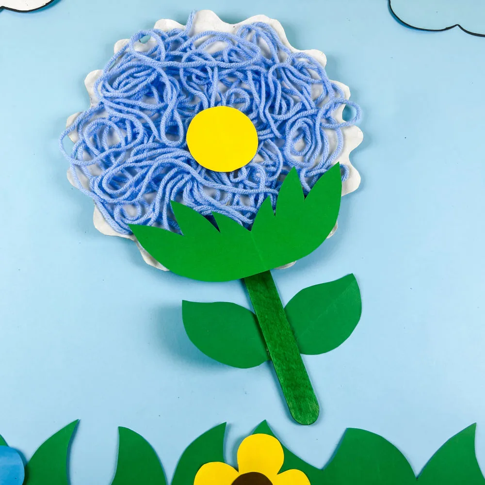 Yarn Flower Craft -- a hands-on art project where kids explore texture and design while strengthening coordination and creative expression.