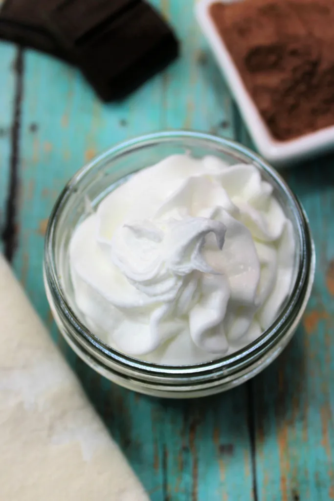 Homemade body butter combines cocoa butter, coconut oil and peppermint essential oil into a fluffy whipped moisturizer.