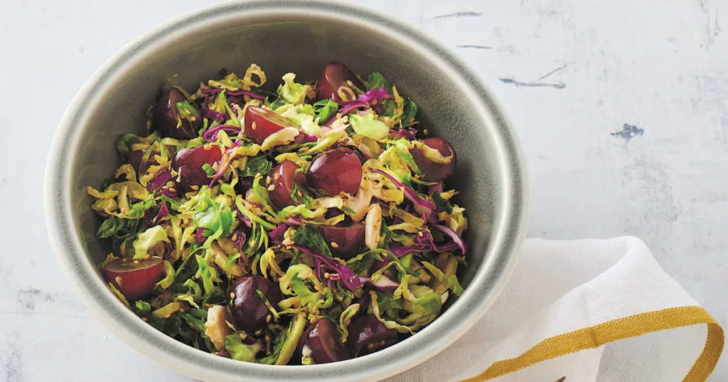 This Brussels sprout slaw is a colorful, refreshing side that combines crisp veggies, sweet fruit and a zesty, nutty dressing for a crowd-pleasing dish.
