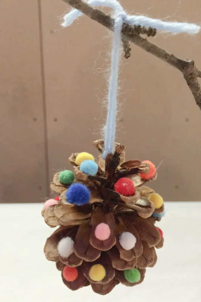 This pinecone ornament is a simple, meaningful way for kids to create handmade holiday decor that feels both festive and personal.